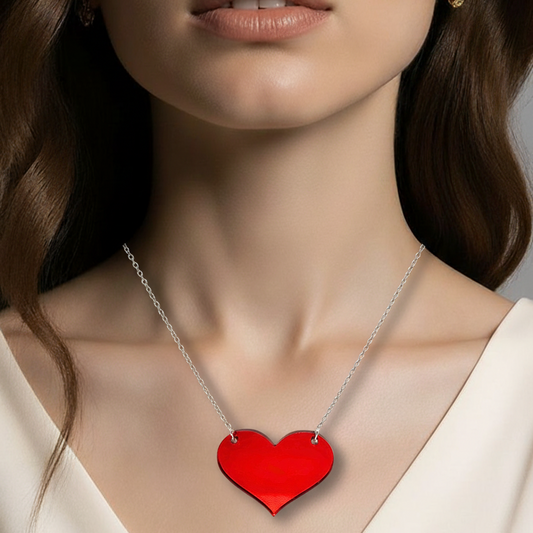 Red heart-shaped necklace on a model with a neutral background