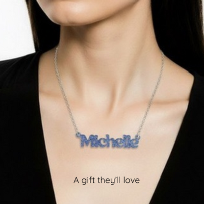 Necklace with 'Michelle' pendant on a person wearing a black top.
