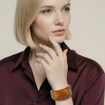 Woman wearing a maroon shirt with a neutral background