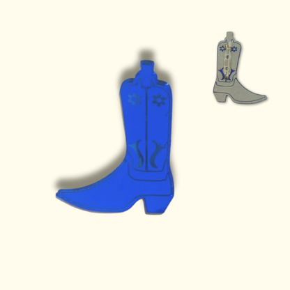 Blue cowboy boot-shaped pinon a white background