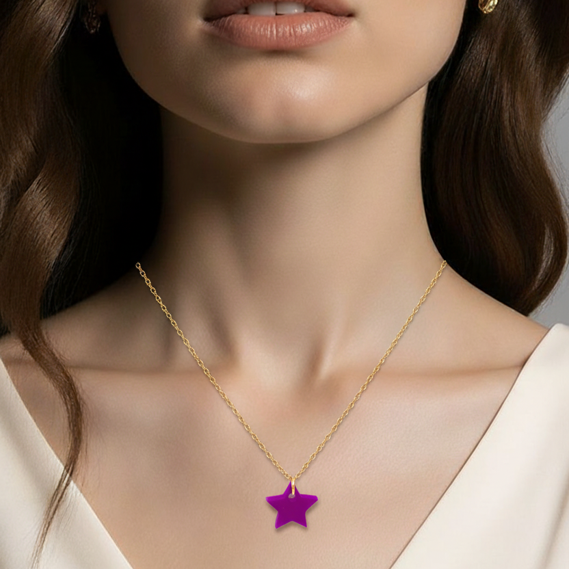 Close-up of a woman wearing a gold necklace with a purple star pendant.