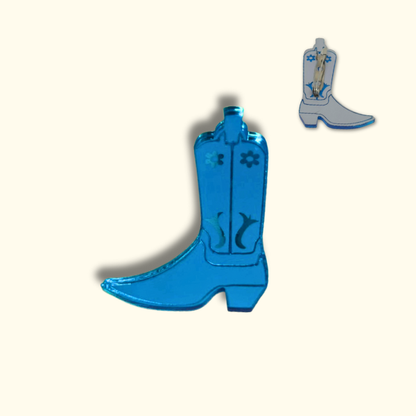 Blue cowboy boot-shaped pin on a white background